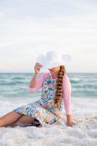 Model wearing Nuggles® Sport Swim Dress in Daisy Daydream