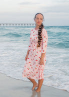 Model wearing Nuggles® Nola Sport Swim Dress in Cherry Soda Shop