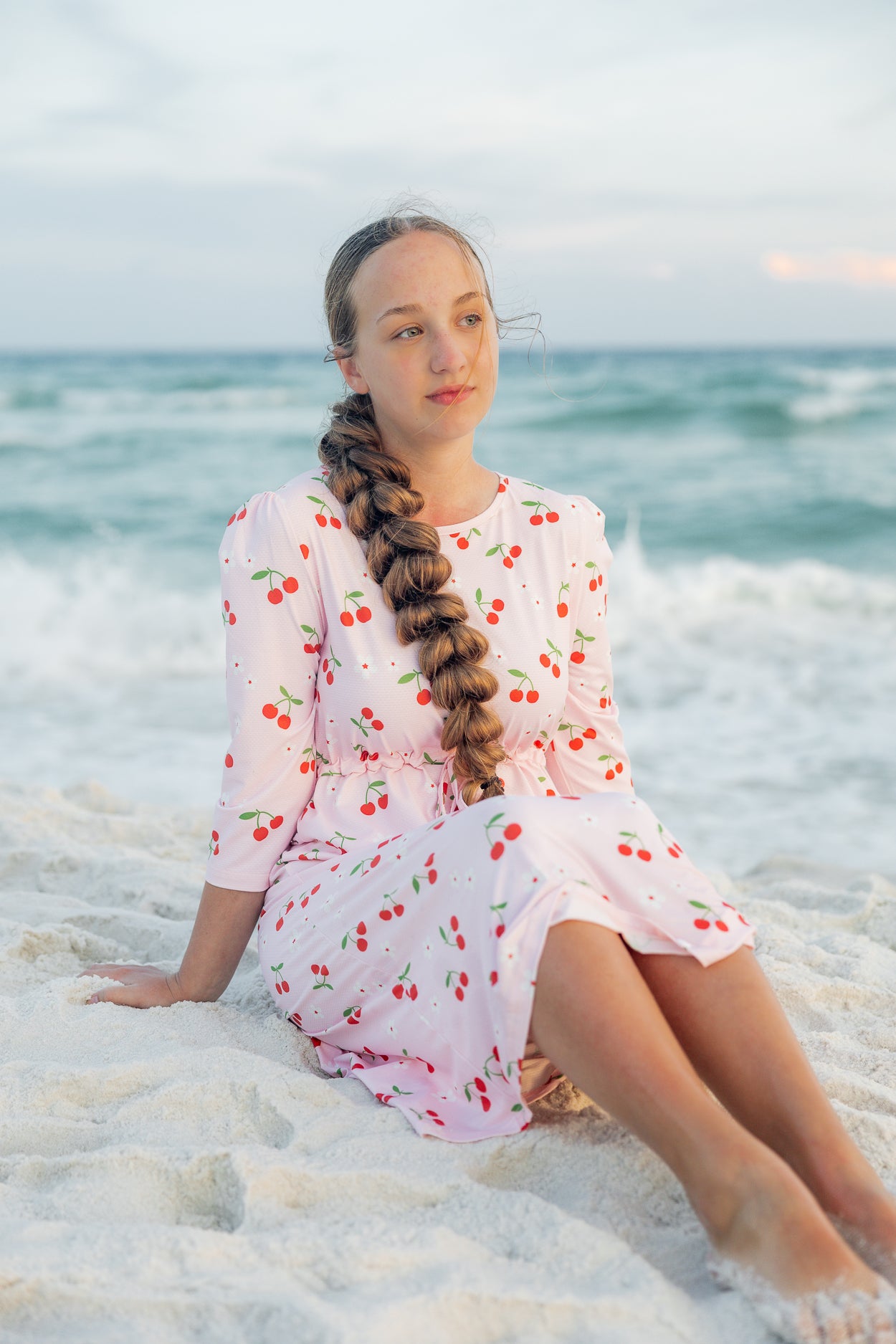 Model wearing Nuggles® Nola Sport Swim Dress in Cherry Soda Shop
