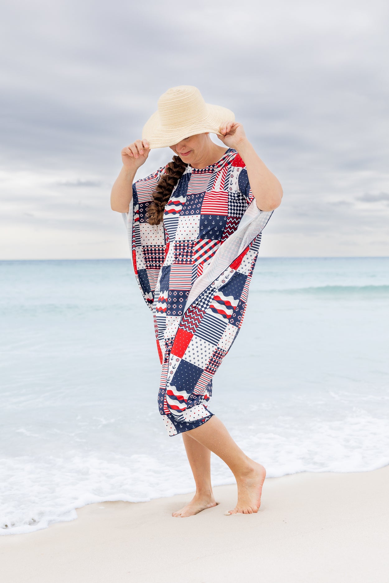 Model wearing Nuggles® Carlie Swim Dress in Boardwalk Patch