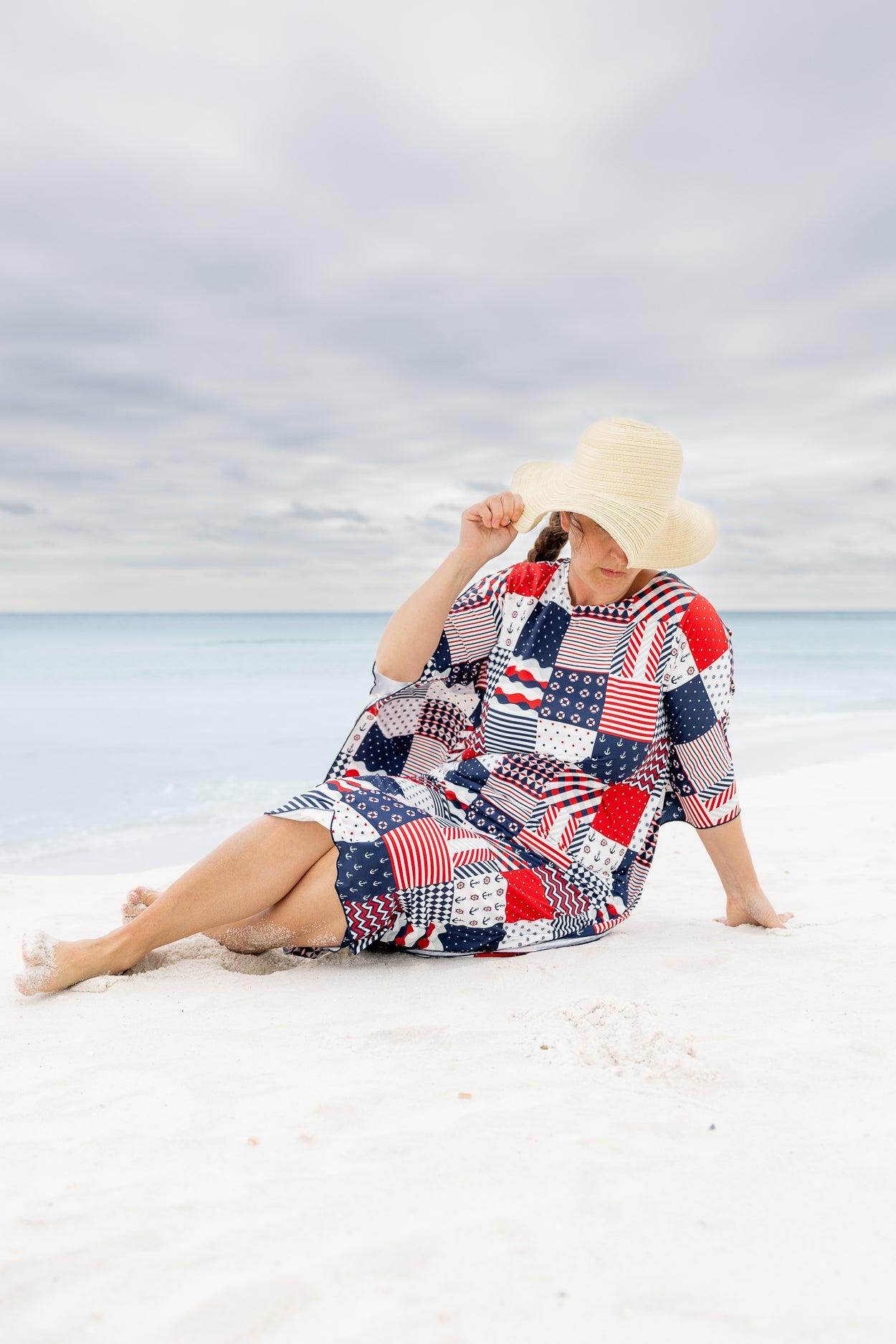 Model wearing Nuggles® Carlie Swim Dress in Boardwalk Patch