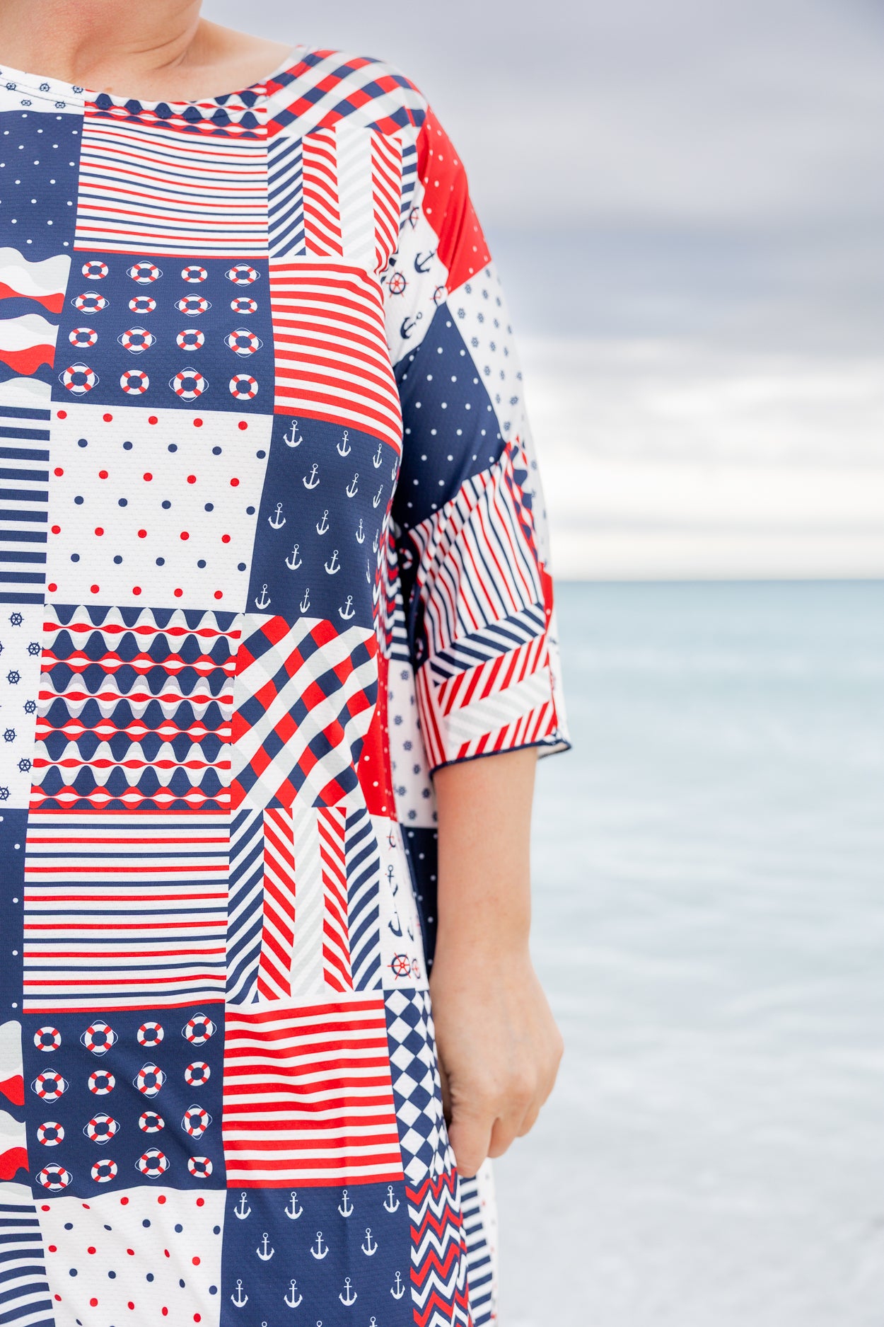 Model wearing Nuggles® Carlie Swim Dress in Boardwalk Patch