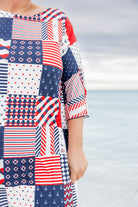 Model wearing Nuggles® Carlie Swim Dress in Boardwalk Patch