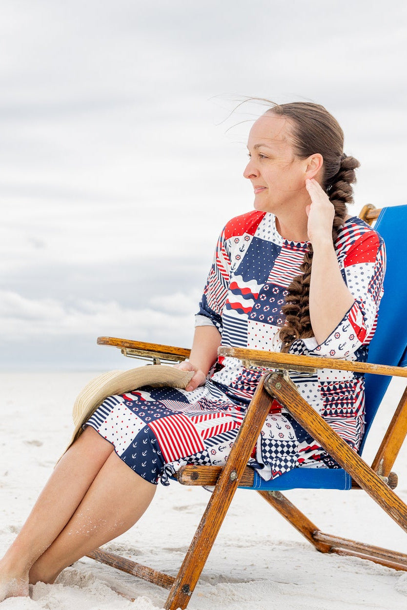 Model wearing Nuggles® Carlie Swim Dress in Boardwalk Patch