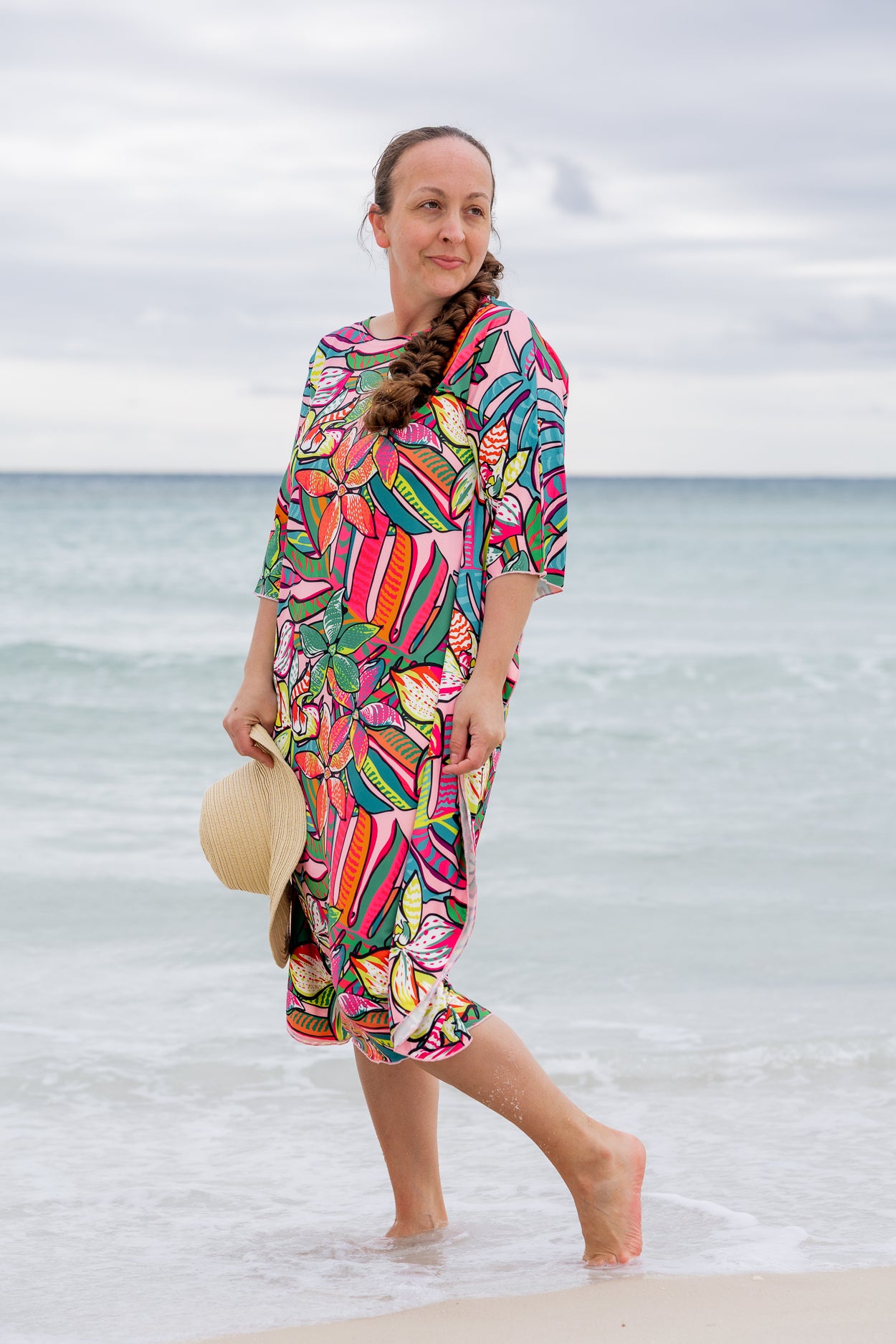 Model wearing Nuggles® Carlie Swim Dress in Aloha Bloom