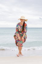 Model wearing Nuggles® Carlie Swim Dress in Aloha Bloom
