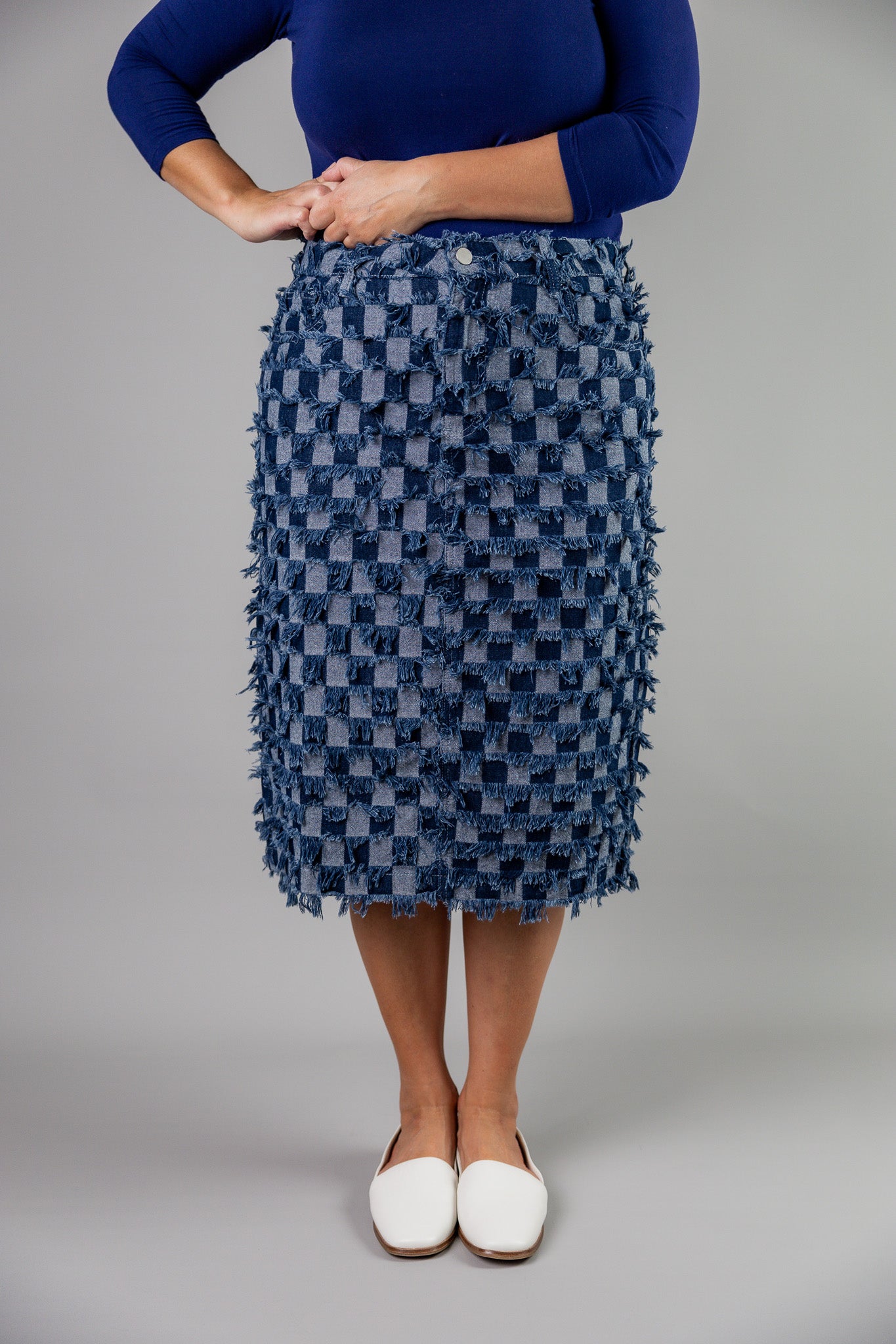 Nuggles® denim midi skirt with soft stretch fabric, wide elastic waistband, modest length, and functional pockets. Available in 27", 31", and 34" lengths.