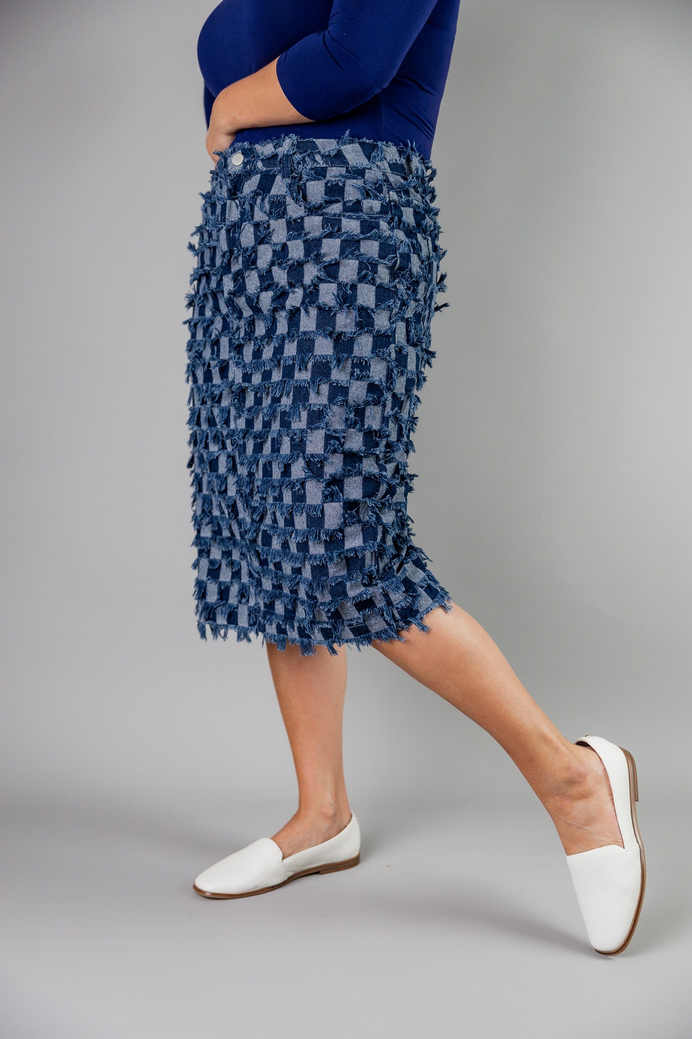Nuggles® denim midi skirt with soft stretch fabric, wide elastic waistband, modest length, and functional pockets. Available in 27", 31", and 34" lengths.