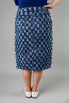 Nuggles® denim midi skirt with soft stretch fabric, wide elastic waistband, modest length, and functional pockets. Available in 27", 31", and 34" lengths.