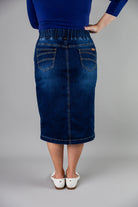 Nuggles® denim midi skirt with soft stretch fabric, wide elastic waistband, modest length, and functional pockets. Available in 27", 31", and 34" lengths.