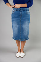 Nuggles® denim midi skirt with soft stretch fabric, wide elastic waistband, modest length, and functional pockets. Available in 27", 31", and 34" lengths.