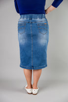 Nuggles® denim midi skirt with soft stretch fabric, wide elastic waistband, modest length, and functional pockets. Available in 27", 31", and 34" lengths.