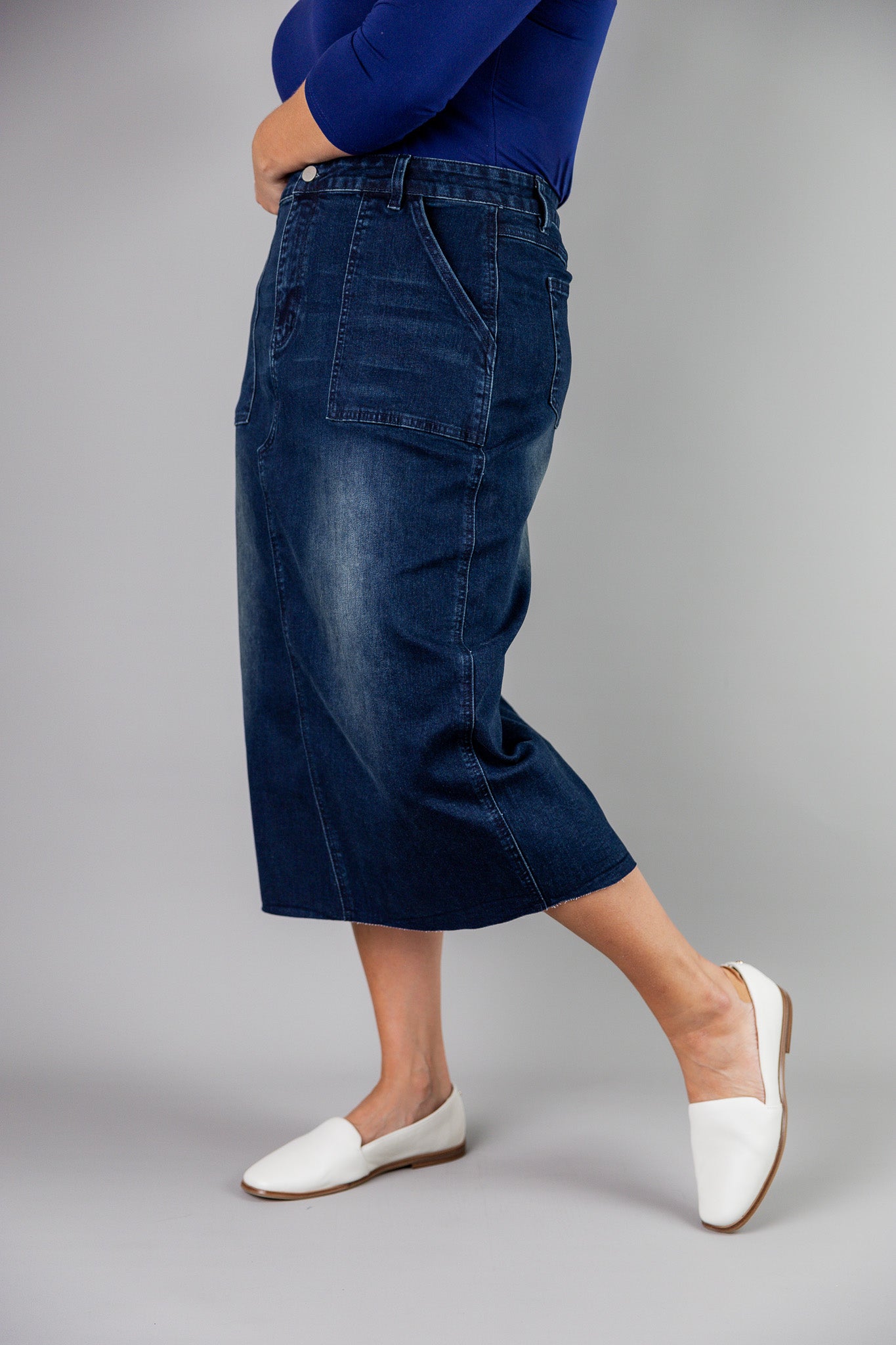 Nuggles® denim midi skirt with soft stretch fabric, wide elastic waistband, modest length, and functional pockets. Available in 27", 31", and 34" lengths.