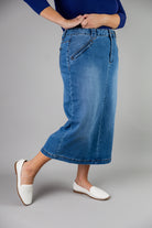 Nuggles® denim midi skirt with soft stretch fabric, wide elastic waistband, modest length, and functional pockets. Available in 27", 31", and 34" lengths.