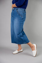 Nuggles® denim midi skirt with soft stretch fabric, wide elastic waistband, modest length, and functional pockets. Available in 27", 31", and 34" lengths.