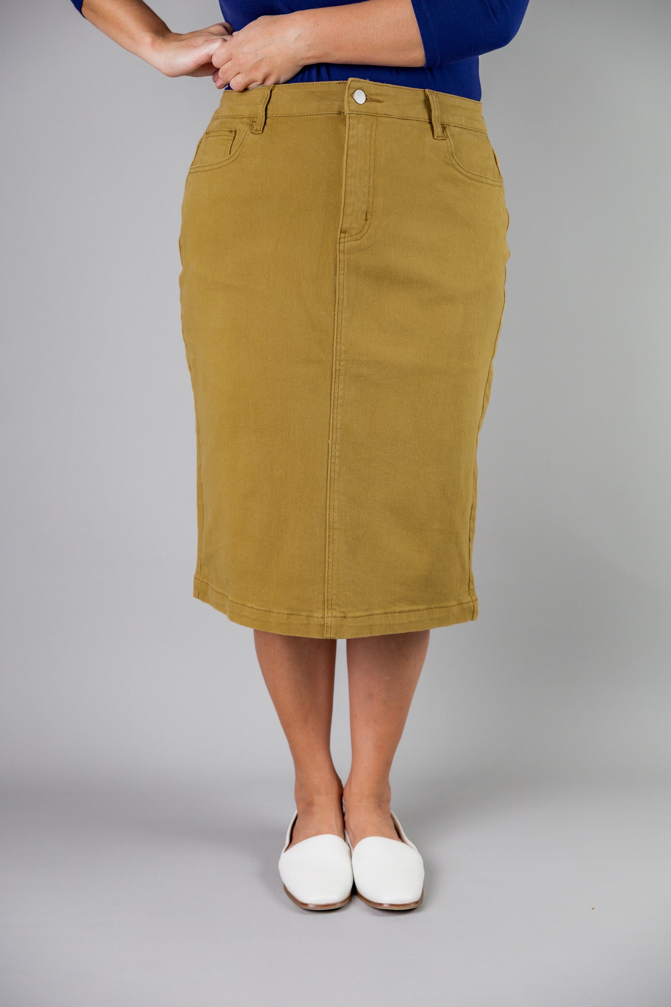 Nuggles® denim midi skirt with soft stretch fabric, wide elastic waistband, modest length, and functional pockets. Available in 27", 31", and 34" lengths.