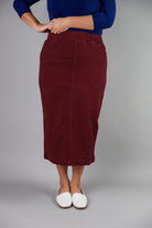 Nuggles® denim midi skirt with soft stretch fabric, wide elastic waistband, modest length, and functional pockets. Available in 27", 31", and 34" lengths.