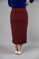 Nuggles® denim midi skirt with soft stretch fabric, wide elastic waistband, modest length, and functional pockets. Available in 27", 31", and 34" lengths.