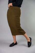 Nuggles® denim midi skirt with soft stretch fabric, wide elastic waistband, modest length, and functional pockets. Available in 27", 31", and 34" lengths.