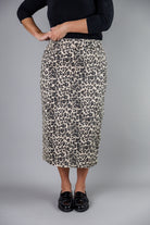 Nuggles® denim midi skirt with soft stretch fabric, wide elastic waistband, modest length, and functional pockets. Available in 27", 31", and 34" lengths.