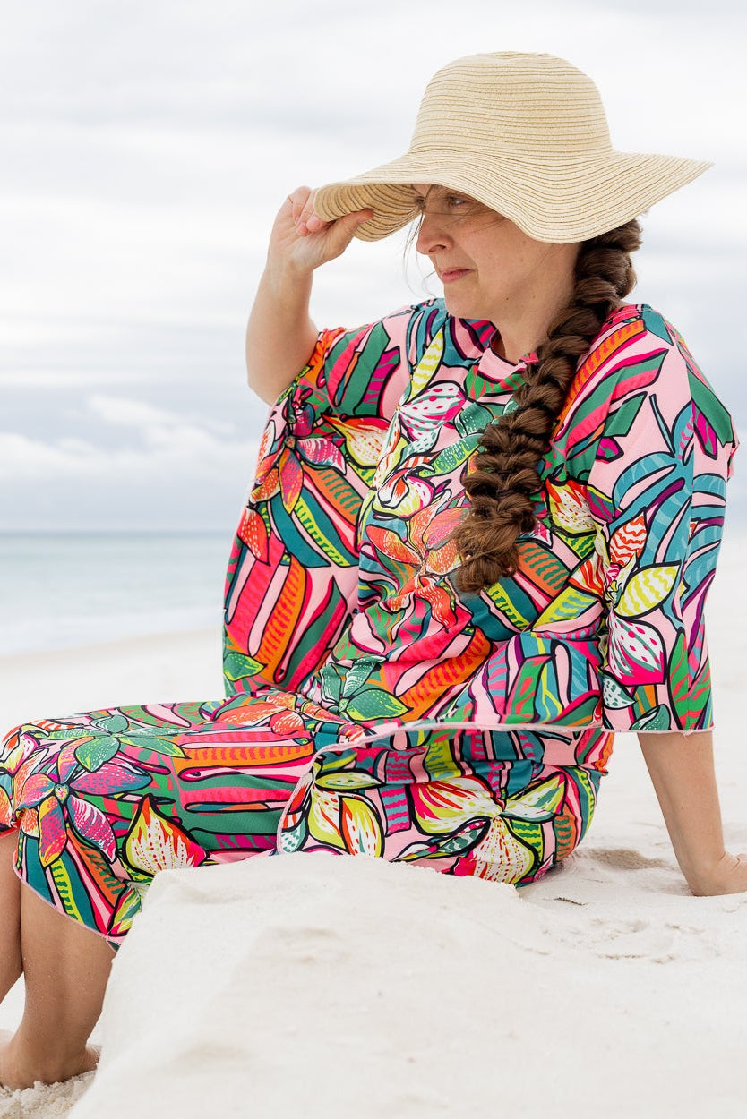 Model wearing Nuggles® Carlie Swim Dress in Aloha Bloom