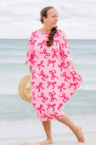 Model wearing Nuggles® Carlie Swim Dress in Pretty Bow