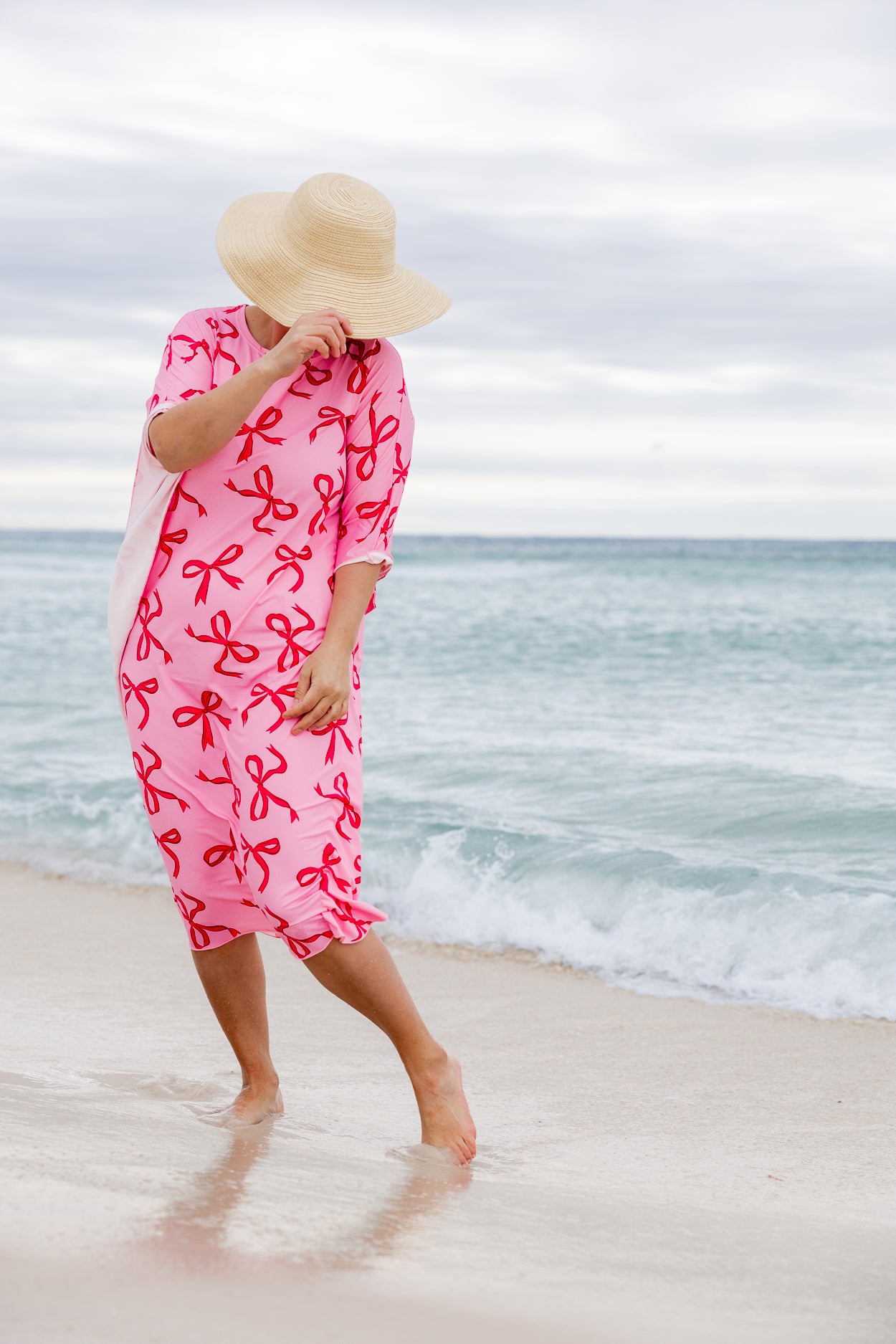 Model wearing Nuggles® Carlie Swim Dress in Pretty Bow