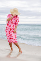 Model wearing Nuggles® Carlie Swim Dress in Pretty Bow