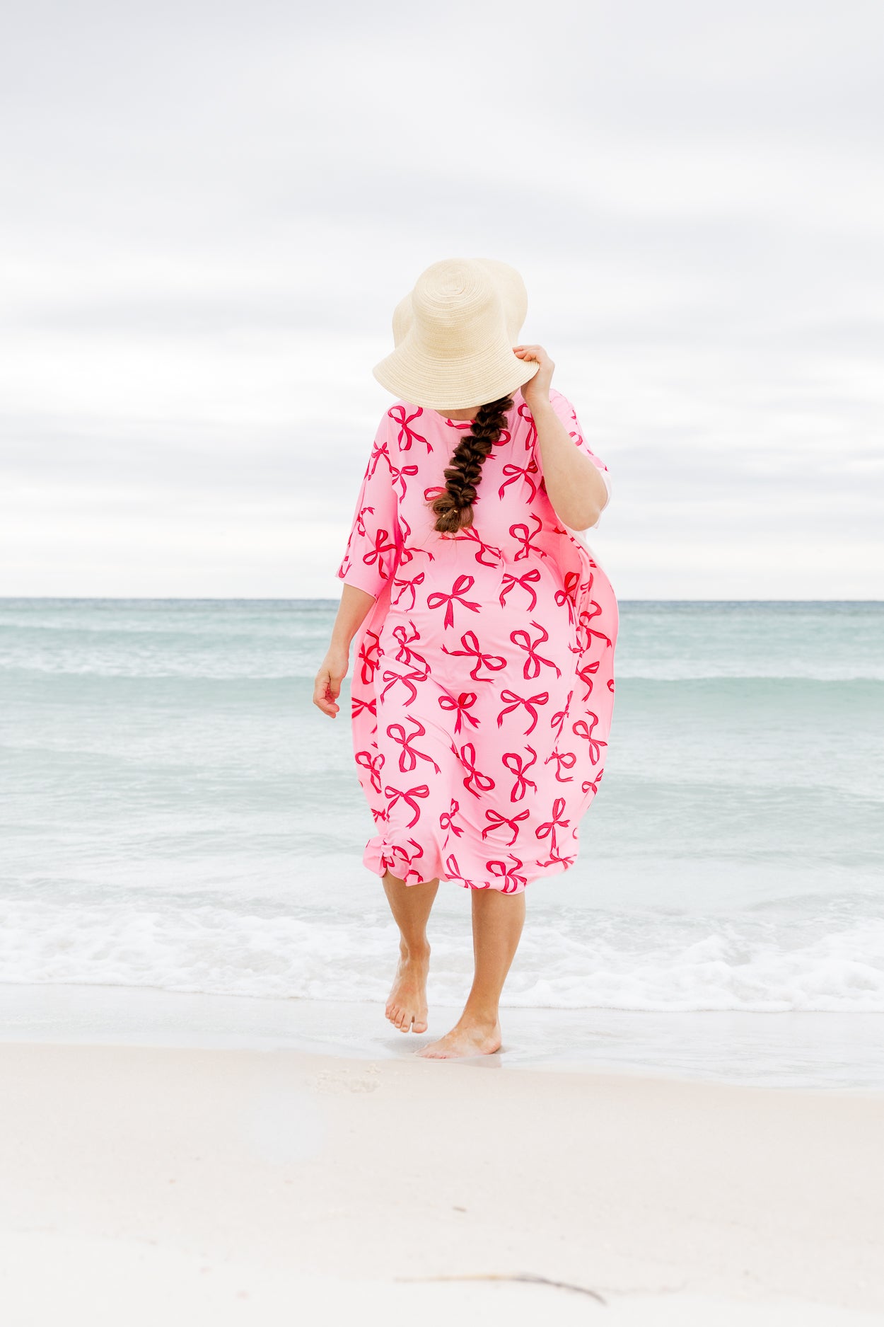 Model wearing Nuggles® Carlie Swim Dress in Pretty Bow