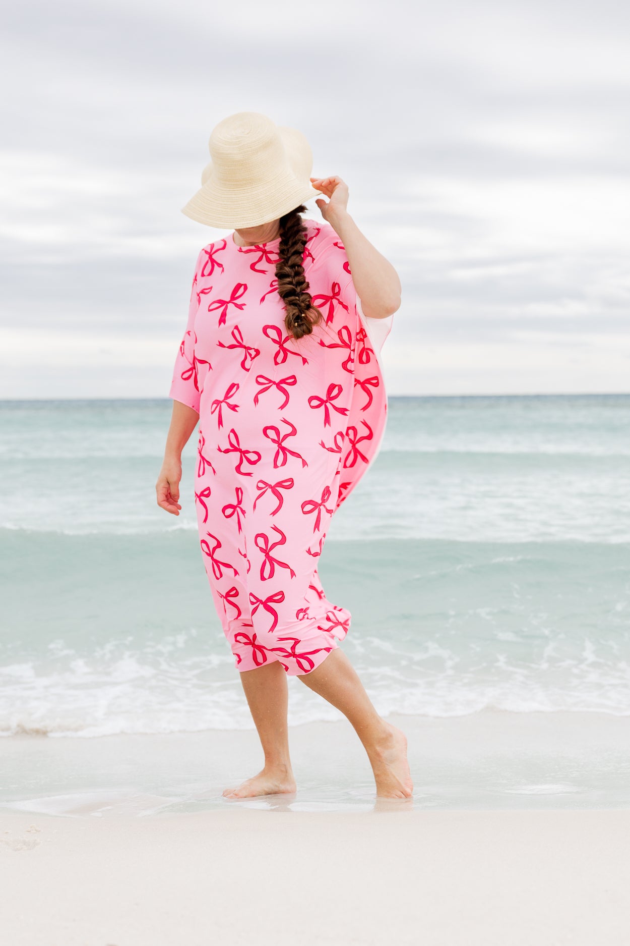 Model wearing Nuggles® Carlie Swim Dress in Pretty Bow
