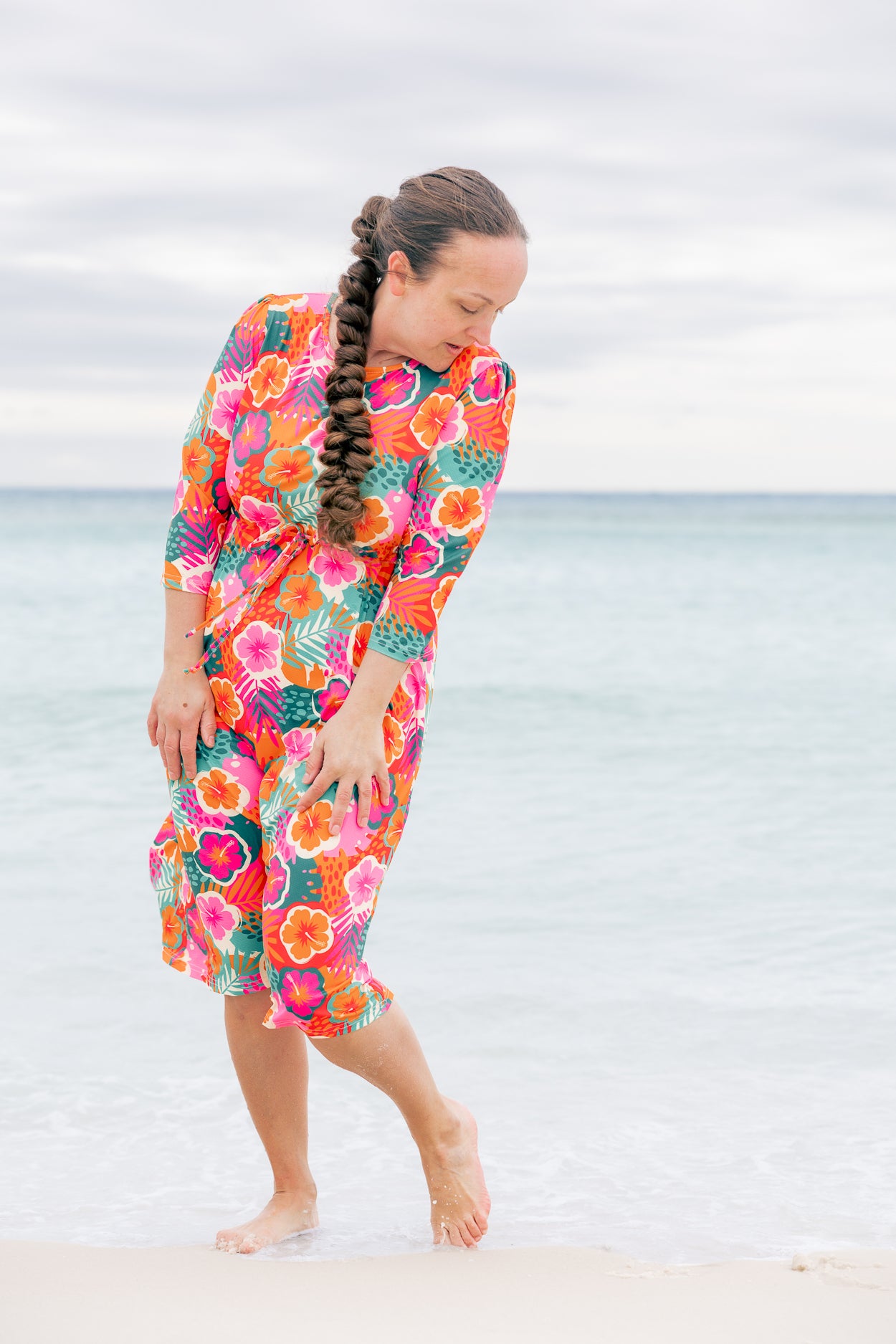 Model wearing Nuggles® Nola Sport Swim Dress in Luau Garden