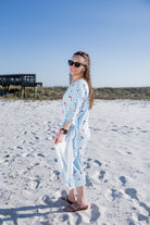 Model wearing Nuggles® Carlie Swim Dress in Sweet Cherry Check