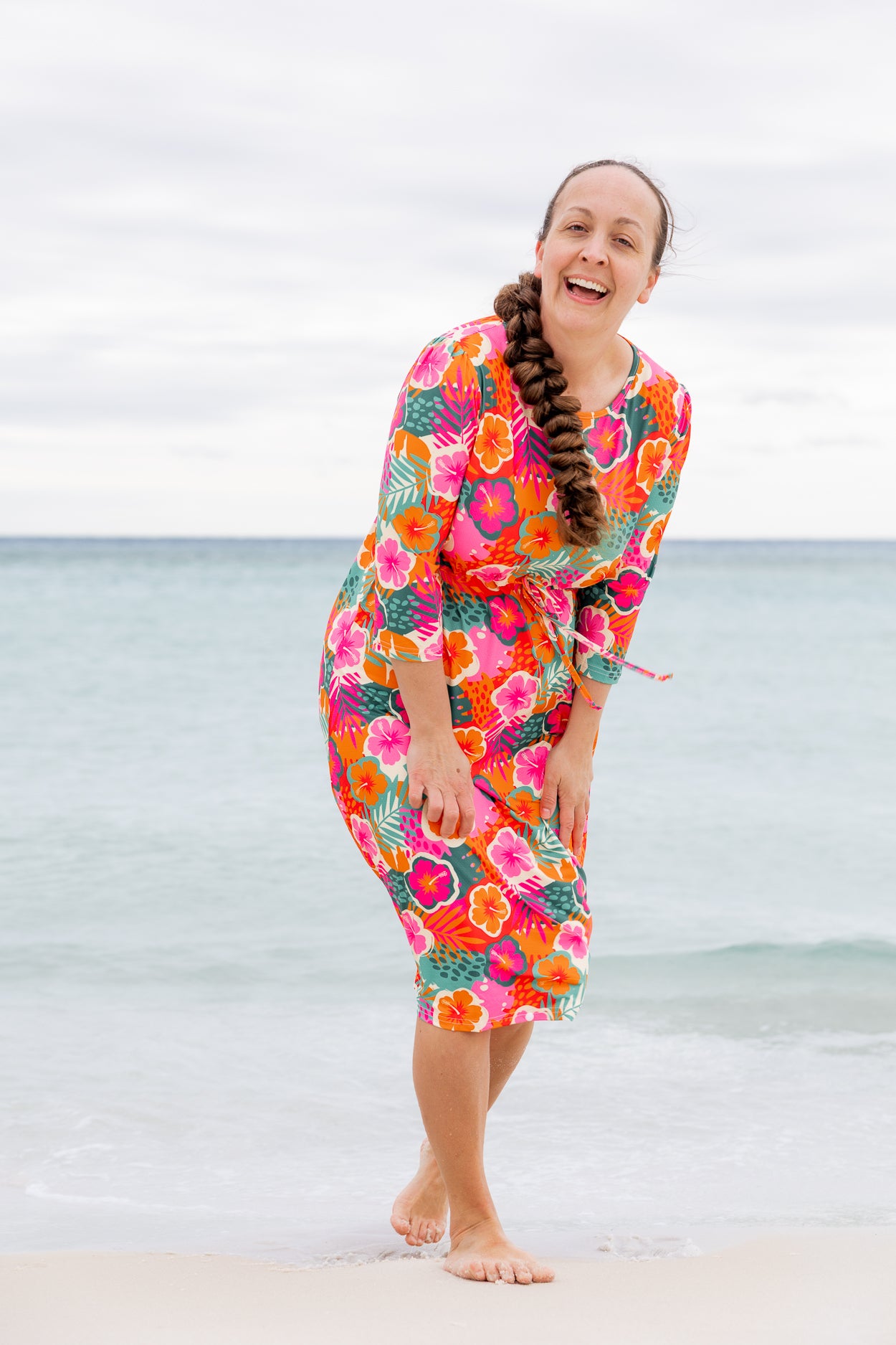Model wearing Nuggles® Nola Sport Swim Dress in Luau Garden