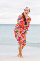 Model wearing Nuggles® Nola Sport Swim Dress in Luau Garden