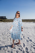 Model wearing Nuggles® Carlie Swim Dress in Sweet Cherry Check