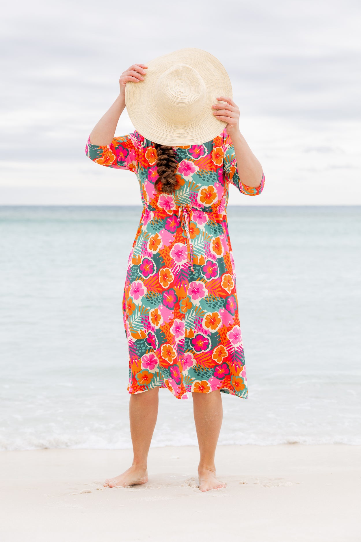 Model wearing Nuggles® Nola Sport Swim Dress in Luau Garden