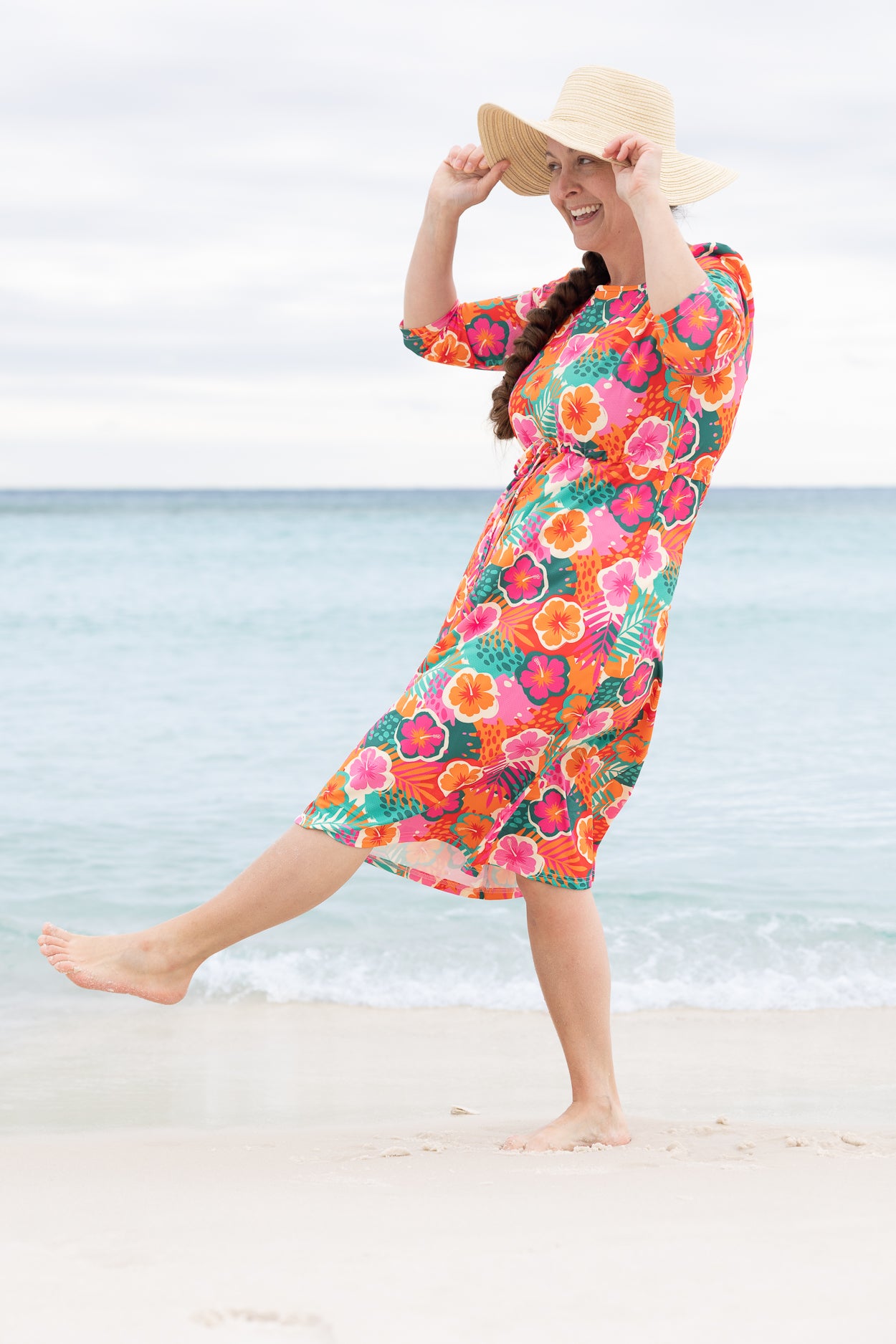 Model wearing Nuggles® Nola Sport Swim Dress in Luau Garden
