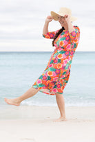 Model wearing Nuggles® Nola Sport Swim Dress in Luau Garden