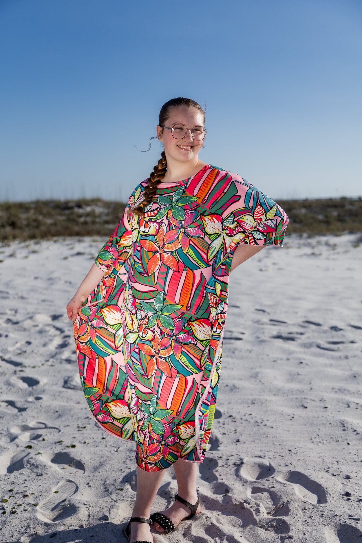 Model wearing Nuggles® Carlie Swim Dress in Aloha Bloom