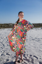 Model wearing Nuggles® Carlie Swim Dress in Aloha Bloom