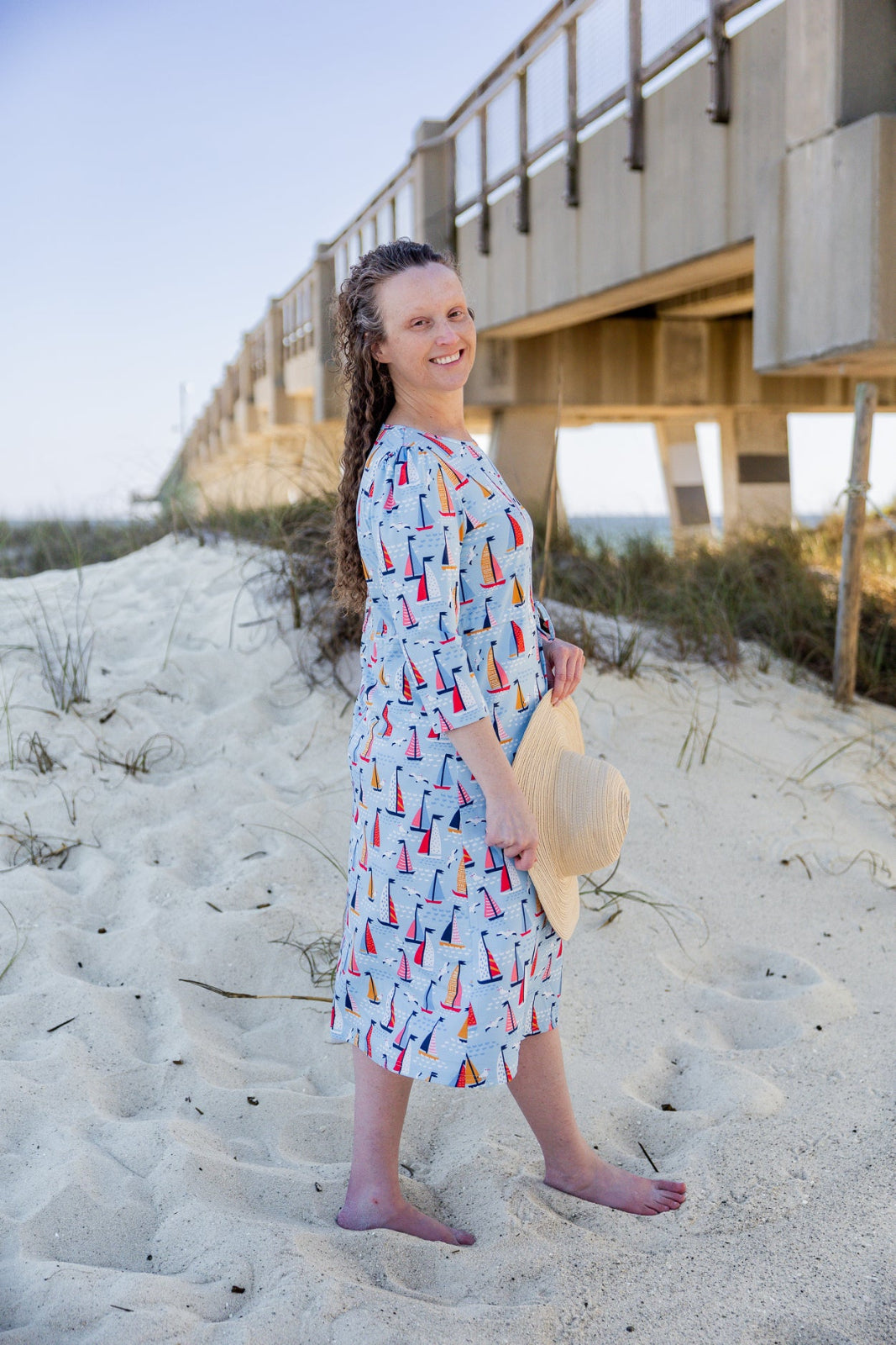 Model wearing Nuggles® Nola Sport Swim Dress in Harbor Sailboats 
