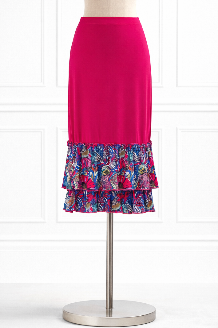Mannequin wearing a bright pink skirt with a floral patterned bottom section on a white background