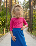 Model wearing Nuggles® Girls All-Sport Skirt in Lapiz Blue