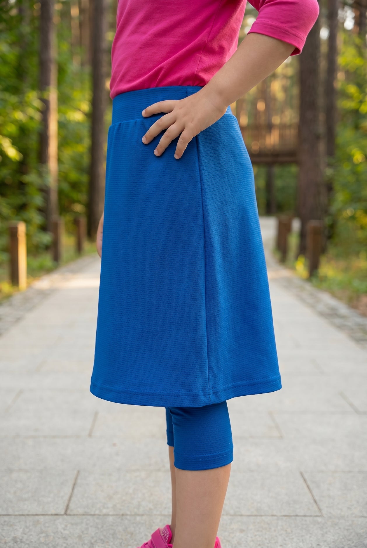 Model wearing Nuggles® Girls All-Sport Skirt in Lapiz Blue