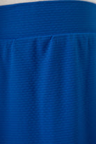 Model wearing Nuggles® Girls All-Sport Skirt in Lapiz Blue