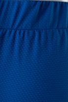 Model wearing Nuggles® 27" All-Sport Skirt in Lapiz Blue