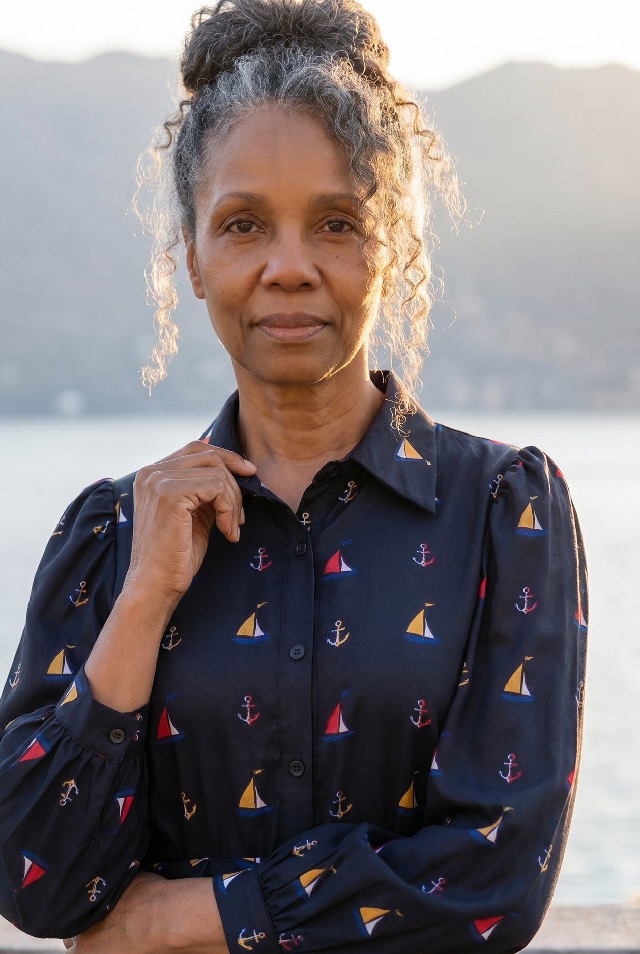 A picture of an older women wearing a blue button down dress. 