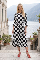 Model wearing Nuggles® Gracie Dress in Midnight Dot 