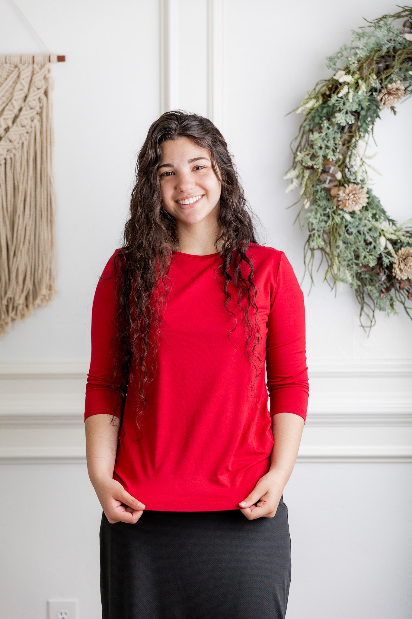 Nuggles® provides modest layering essentials including soft cotton layering shirts. Woman pictured here in one of our red layering essential 3/4 tees. 