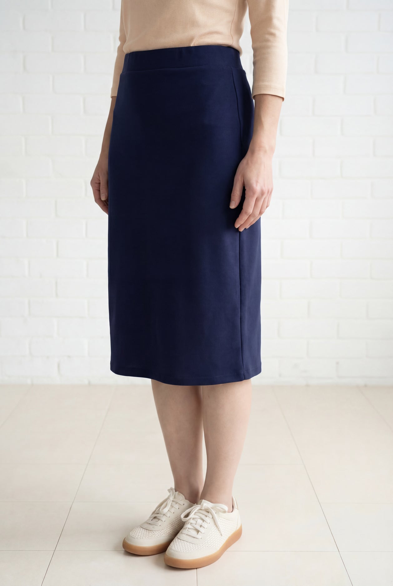 Model wearing Nuggles® 27" Relaxed Midi Skirt in Navy